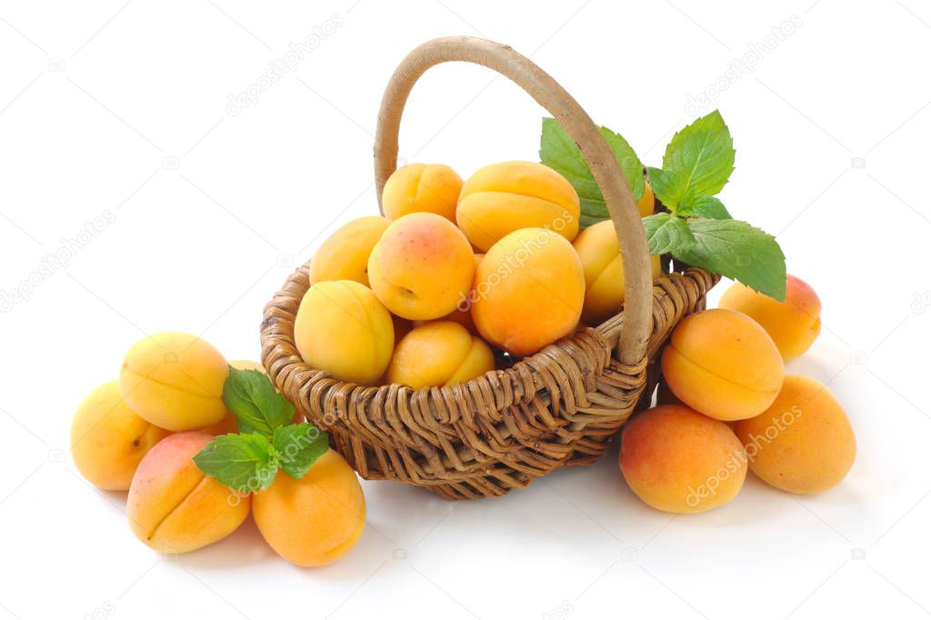 Apricots In A Wicker Basket Isolated On White