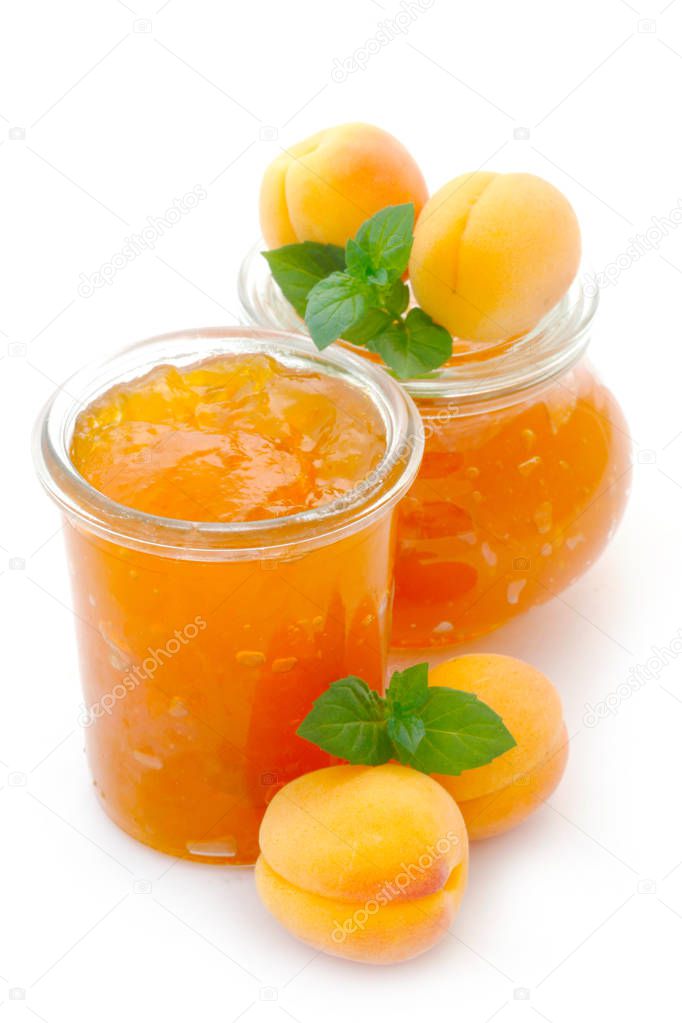 fresh apricot jam in glass jar isolated on white