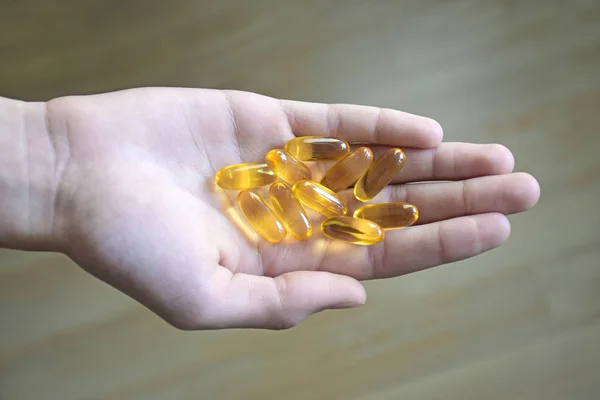 Dietary supplements. Health support and treatment. Realistic yellow gelatin capsule with omega 3. Omega-3 fish oil capsules. Biologically active additives