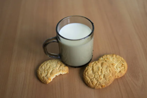 up with milk and cookies with orange zest on wooden background. Cookies and milk - a sweet dessert