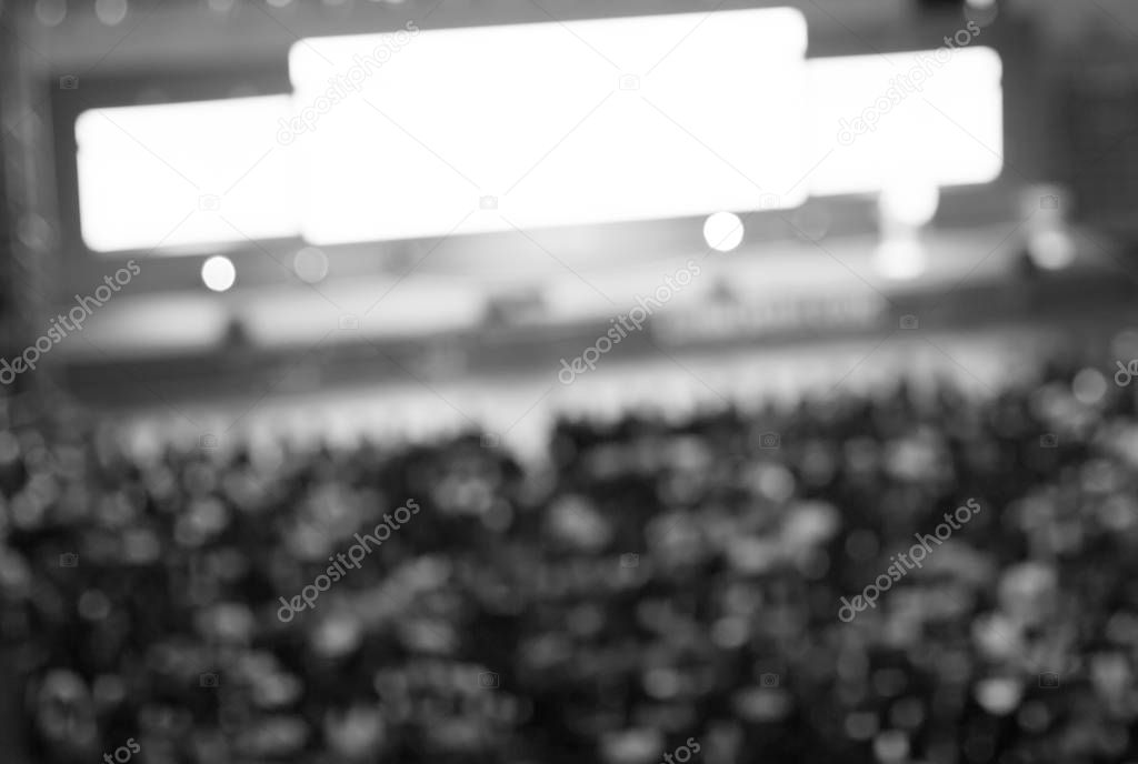 Blurred De-focused Audience in Conference Lecture Presentation Room. Corporate Presentations in Conference Hall. Seminar Speaker Giving Training to New Employees. Blurred  Presenter.