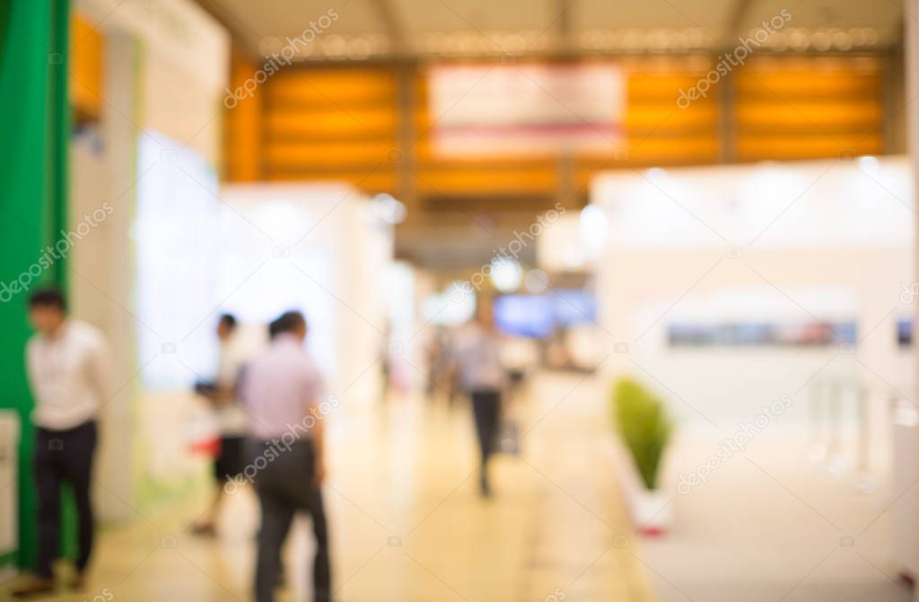 Business convention conference blurred defocused. Retail sales exhibition with people. Business fair expo booth with people shopping. Trade show building interior background with exhibitors.