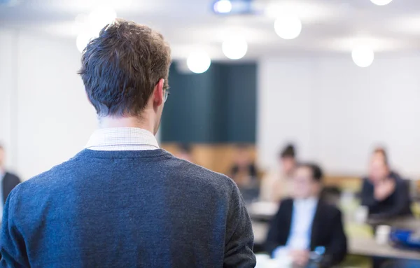 stock image Business man making a presentation at office. Business executive delivering a presentation to his colleagues during meeting or in-house workshop. Rear view. Business and entrepreneurship.