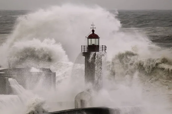Storm at sea. Douro river old pier and lighthouse.