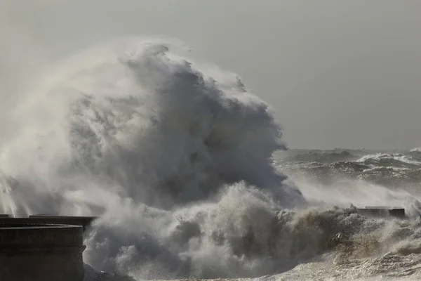 Big stormy wave splash. Douro river mouth pier.