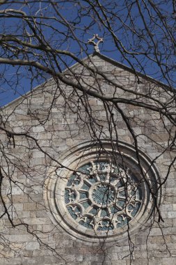 Portekiz 'in kuzeyindeki Vila do Conde adlı çıplak bir ağacın dallarının arkasındaki gizemli ortaçağ Santa Clara manastırı..