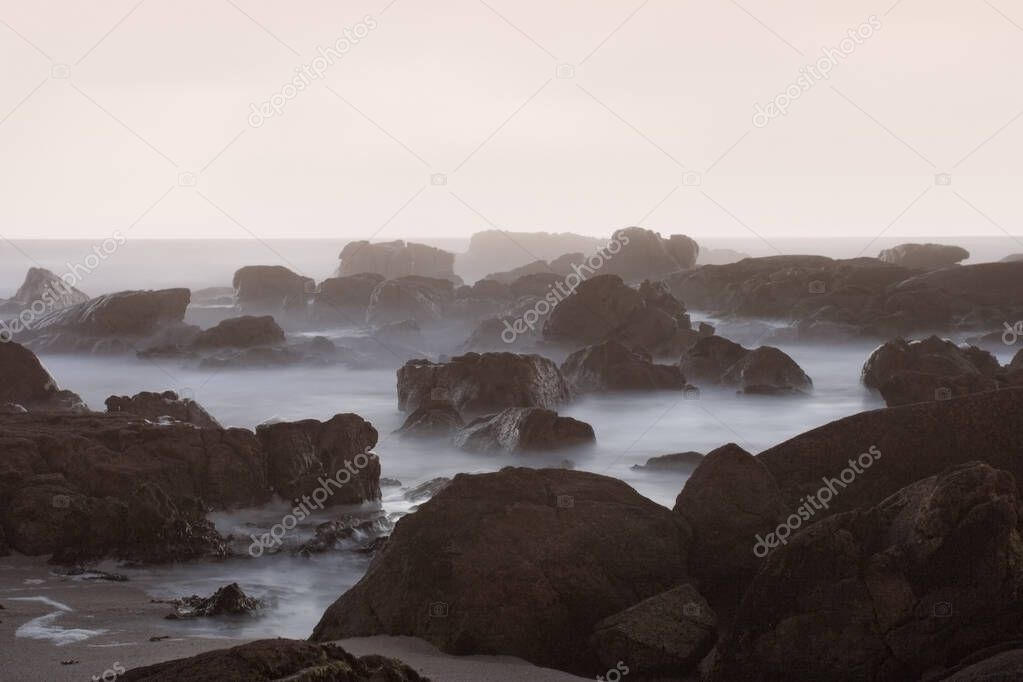 Rocky beach at dusk. Long exposure. Northern portuguese rocky coast.