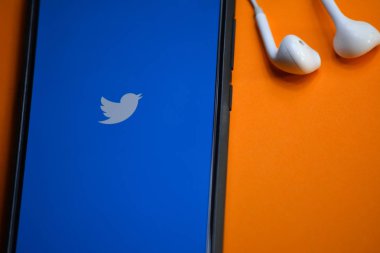 Tikamgarh, Madhya Pradesh, Hindistan - 17 Aralık 2019: Akıllı telefon ekranında ve kulaklıklarda Twitter logosu. Twitter, mikroblog ve ağ iletişimi için bir sosyal medya hizmetidir..