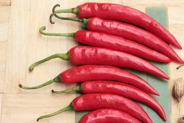 Fresh red hot chilli on wood background — Stock Photo, Image