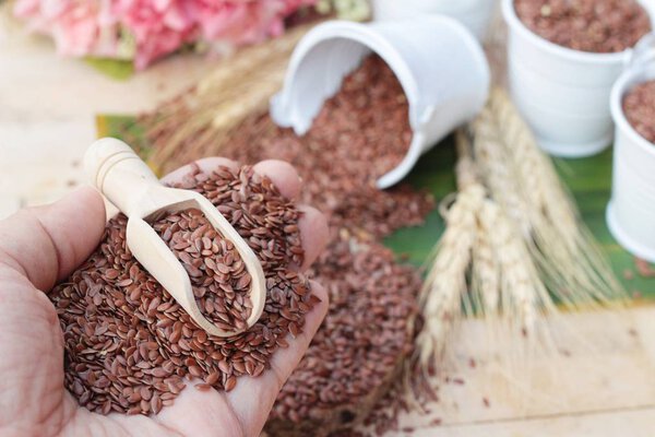 Flax seeds for health on wood background.