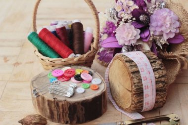 Ahşap arka plan üzerinde Dikiş dikiş aksesuarları