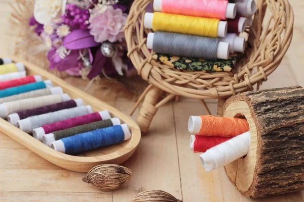 Colorful thread for sewing on wood background — Stock Photo, Image