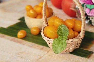 Ahşap arka plan üzerinde organik sarı domates