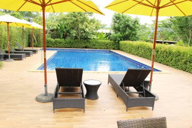 Havuz başında şemsiye ile rahat daybed