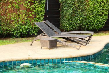 Havuz başında şemsiye ile rahat daybed