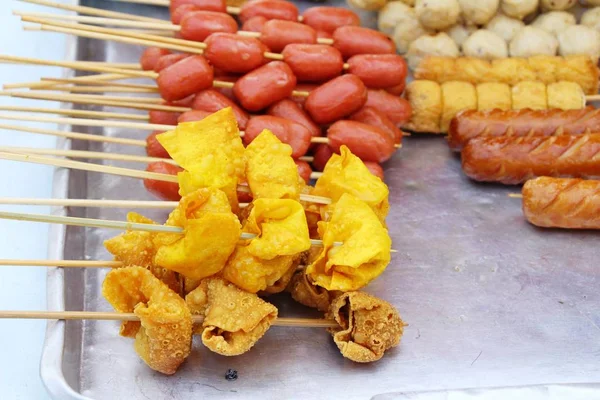 Fried meatballs and sausage at street food — Stock Photo, Image