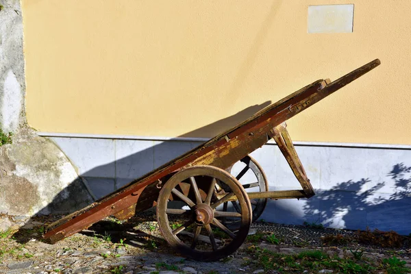ancient wooden cart in front of the church santa maria assunta in granarolo Genoa Italy