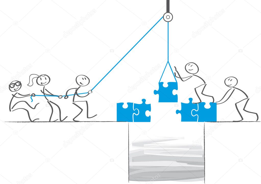 Teamwork - Businessmen collaborate and build a bridge
