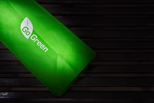 a eco fabric cloth bag with eco green logo isolated on dark background. alternative plastic with eco bag.