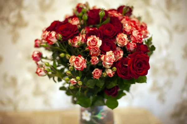 bouquet of colorful roses in a vase on the table