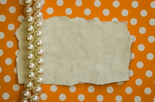 Pearls and orange dotted background — Stock Photo, Image