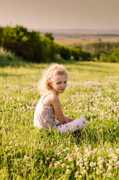 Little Blond Girl Sitting Green Spring Meadow Blossoming Clover Flowers — Stock Photo, Image