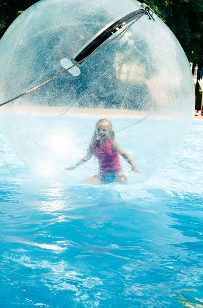 stock image Little child inside the inflatable ball floating on water in swimming pool