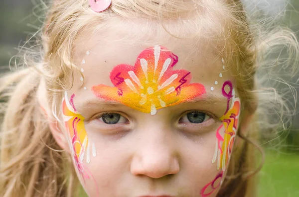 Girl with colorful face-painting Stock Picture