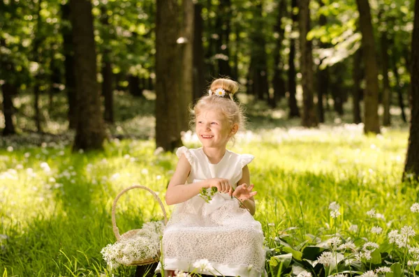 Krásná šťastná dívka v bílých šatech s květinami — Stock fotografie