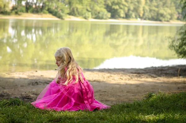 Girl with long hair by the pond — Stock Photo, Image