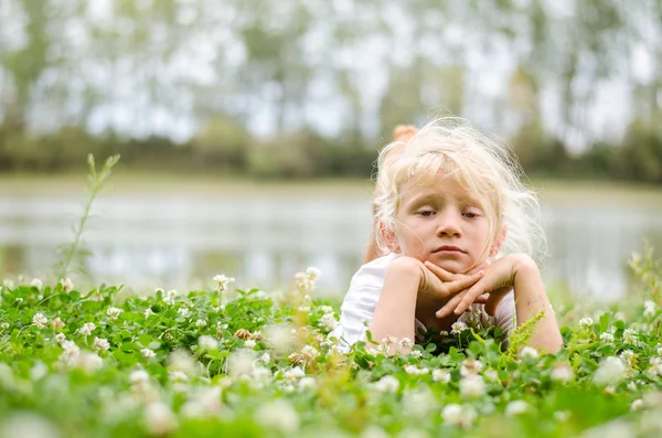 Çim Üzerinde Yalan Hayatın Tadını Çıkarırken Küçük Sevimli Kız — Stok fotoğraf