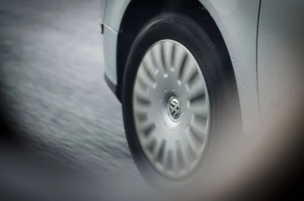 Detail of car tyre on rainy road — Stock Photo, Image