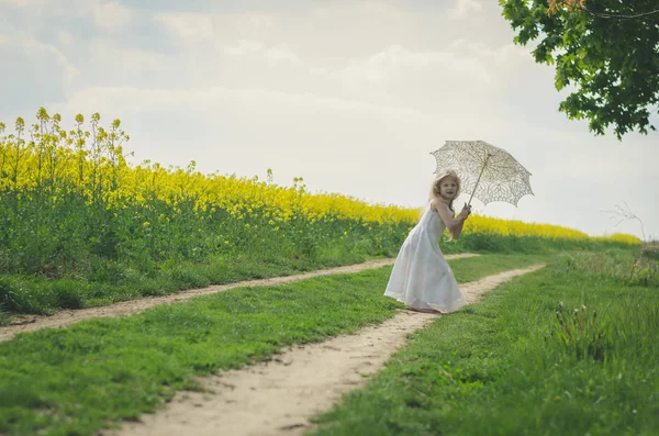 Güzel sarışın kız beyaz güneşlik şemsiyeli poz veriyor. — Stok fotoğraf