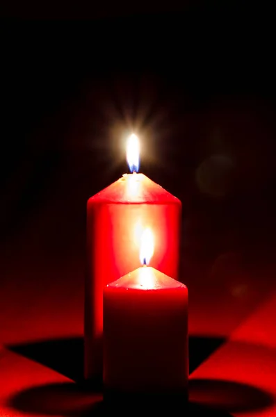 Two Red Illuminated Burning Wax Candles Black Copy Space Background — Stock Photo, Image