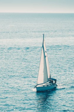 Pembe günbatımında denizde bir tekne