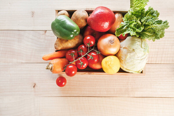 Fresh produce delivery box on wooden background