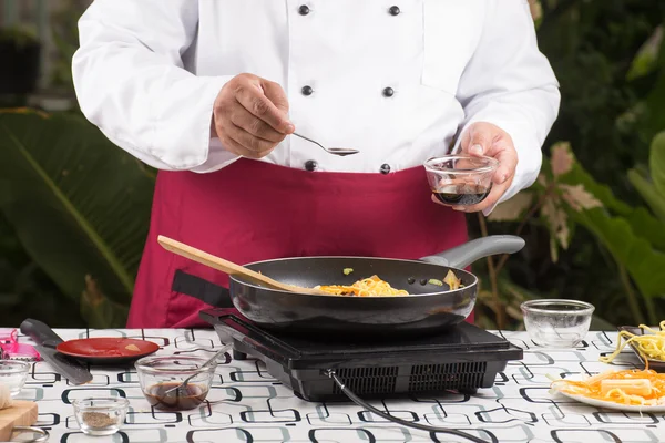 Chef putting soy sauce for cooking / — ストック写真