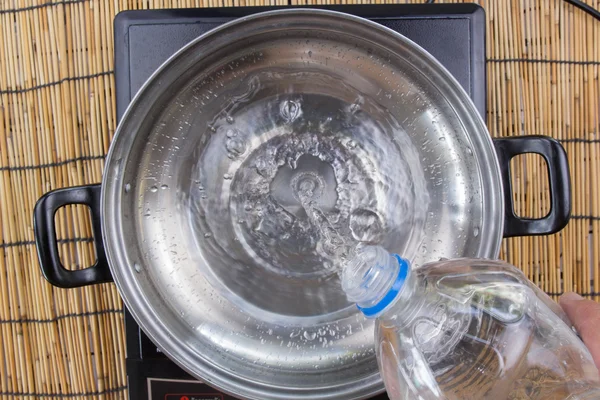 Chef pouring water to pot — Stock Photo, Image