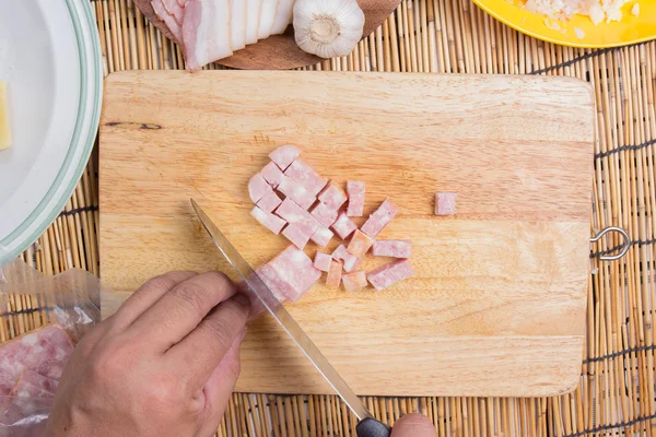 Szakács vágás szalonnát késsel főzés előtt — Stock Fotó