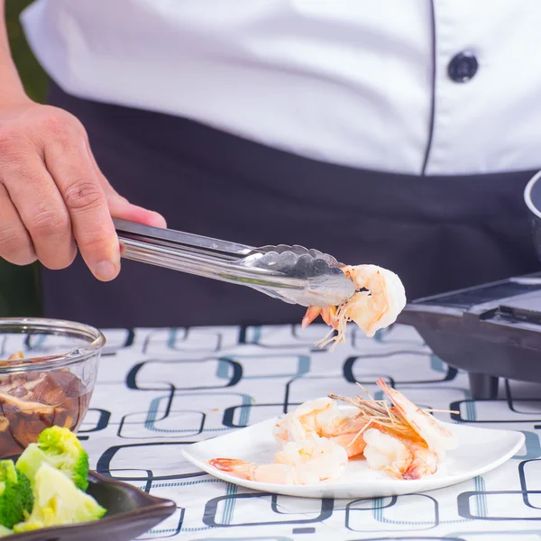 Koch heben kochende Garnelen auf Teller — Stockfoto