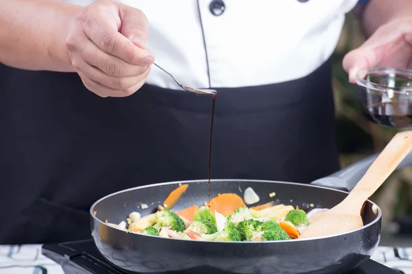 Chef putting soy sauce for cookin — Stock Photo, Image