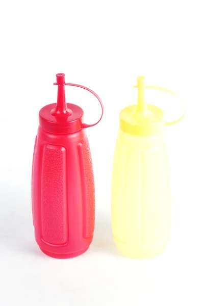 Rode en gele plastic fles — Stockfoto