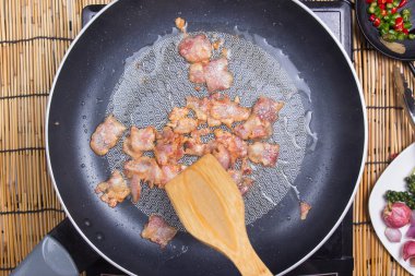 Şef karıştırın kızarmış domuz pastırması pan