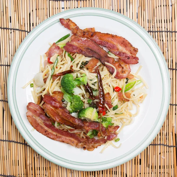 Spicy bacon spaghetti on the plate — Stock Photo, Image