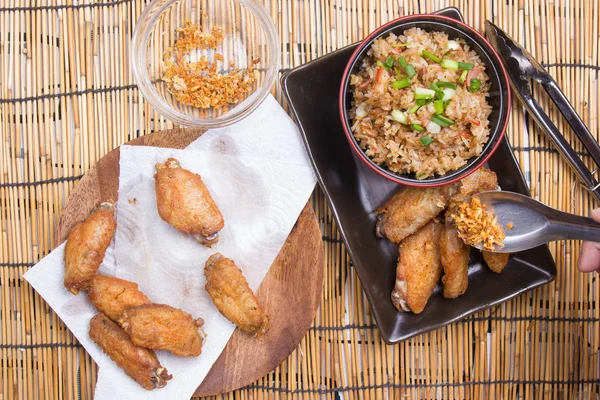 Chef decorated fried chicken wings served with fry rice