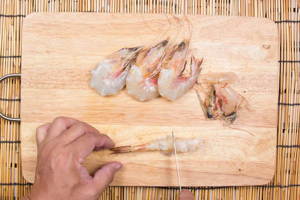 Chef cooking raw shrimp with knife — Stock Photo, Image