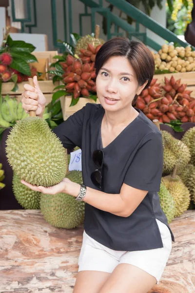 Mooie vrouw met Durian Stockfoto