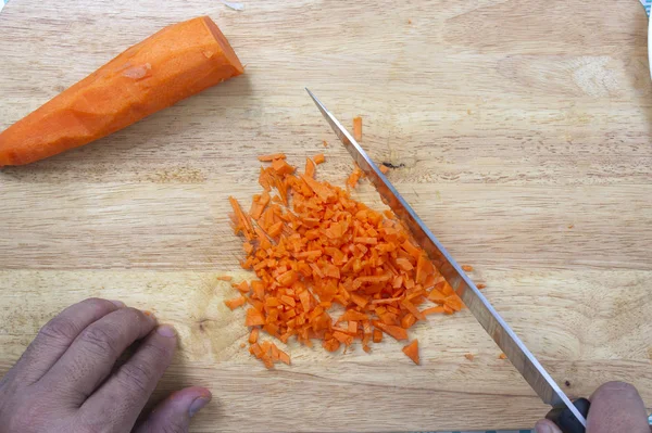 Chef is choping carrots  / Top view