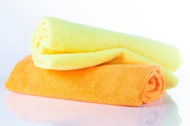 Beyaz arkaplanda turuncu ve sarı kumaşlar mikrofiber izole edilmiş.