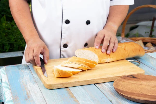 Chef Holding Knife Cutting Slide Bread Making Wooden Board Cooking — Stock Photo, Image